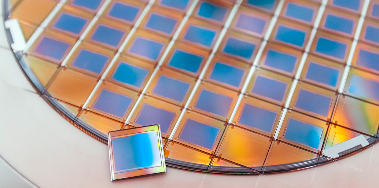 Silicon wafer with microchips fixed in a holder with a steel frame after the dicing process and separate microchips. Silicon Color silicon wafers with glare.